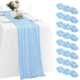 Yorcari baby blue cheesecloth table runner draped gracefully to create a soft, romantic table setting.
