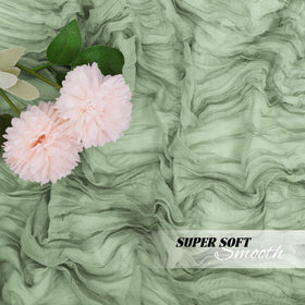 Yorcari sage green gauze runner used as a backdrop for baby showers.