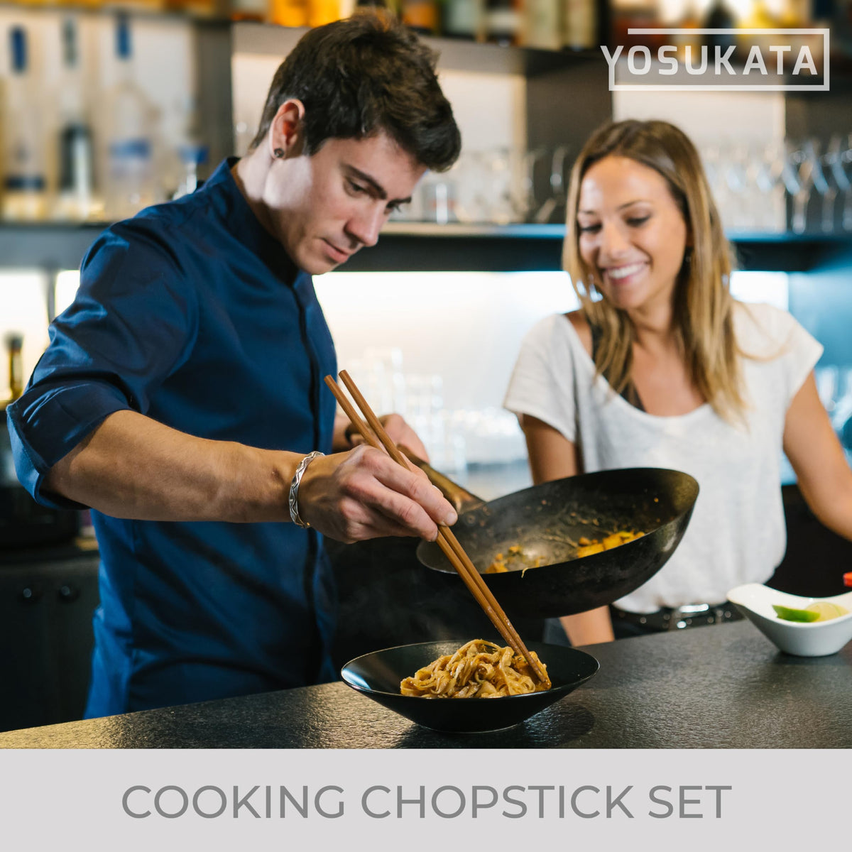 YOSUKATA wooden chopsticks displayed with a wok for frying and mixing.