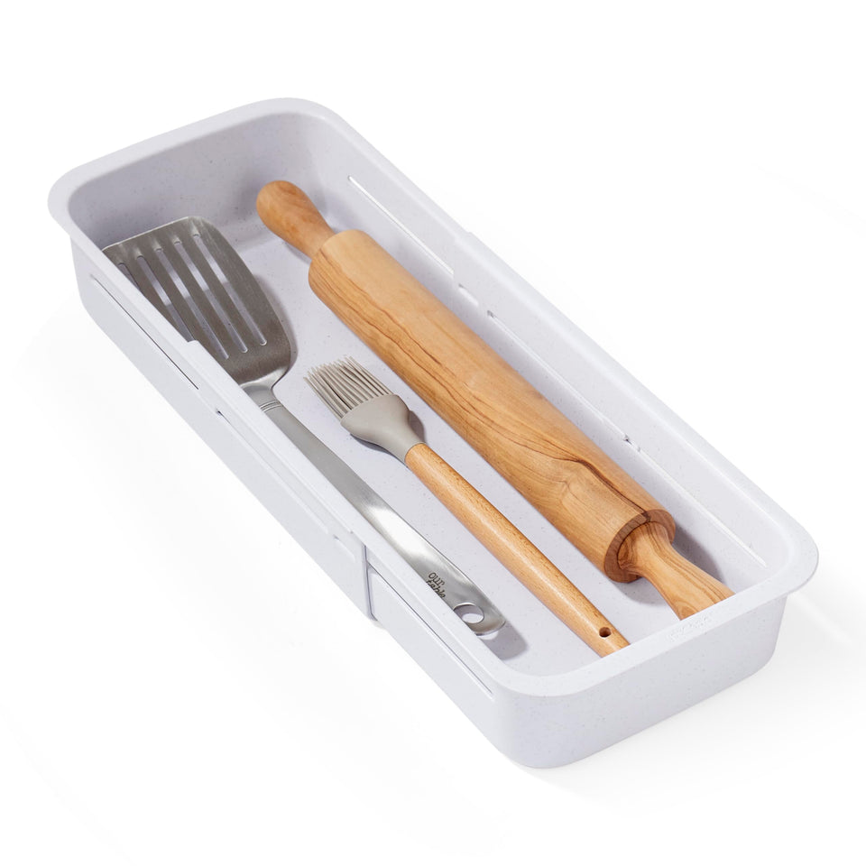 YouCopia DrawerFit sliding bin extended to maximize deep drawer storage for gadgets.