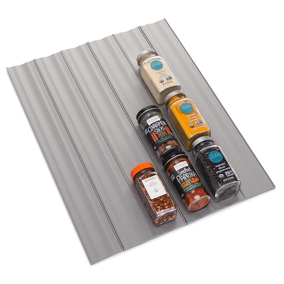 YouCopia SpiceLiner in a drawer organizer showing space for many spice bottles and easy viewing