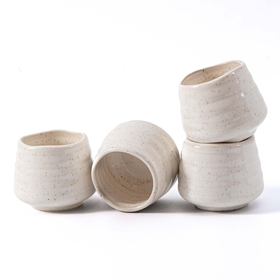 YumiPLUS speckled 5oz tea cup set on white table, ideal for everyday tea rituals.