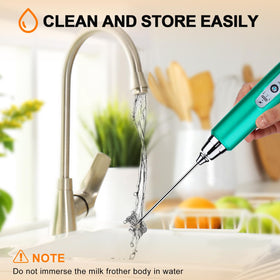 YUSWKO compact frother resting on counter beside coffee mug