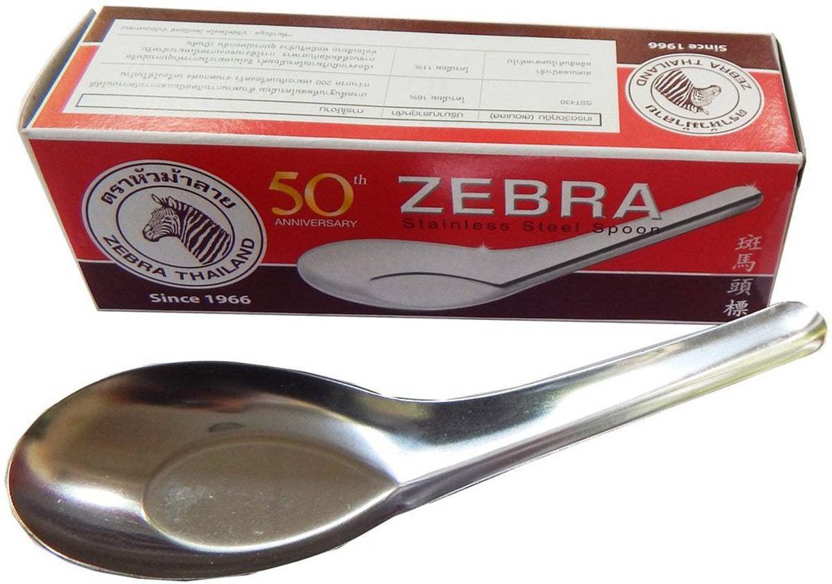 Zebra silver rice soup spoon in use, perfect for bowls of rice and broth.