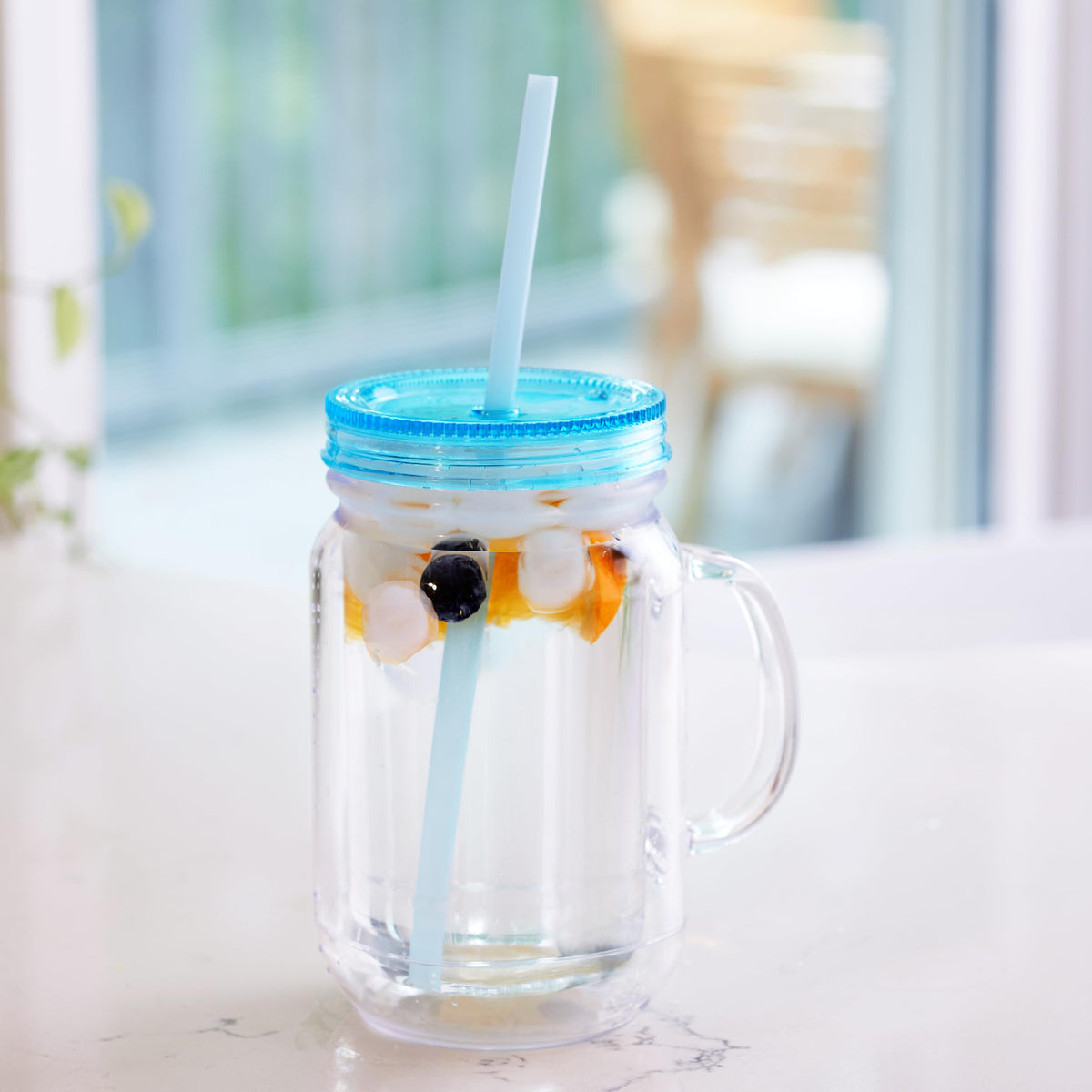 Zephyr Canyon hands holding mason jar with spill-free design for on-the-go sipping.