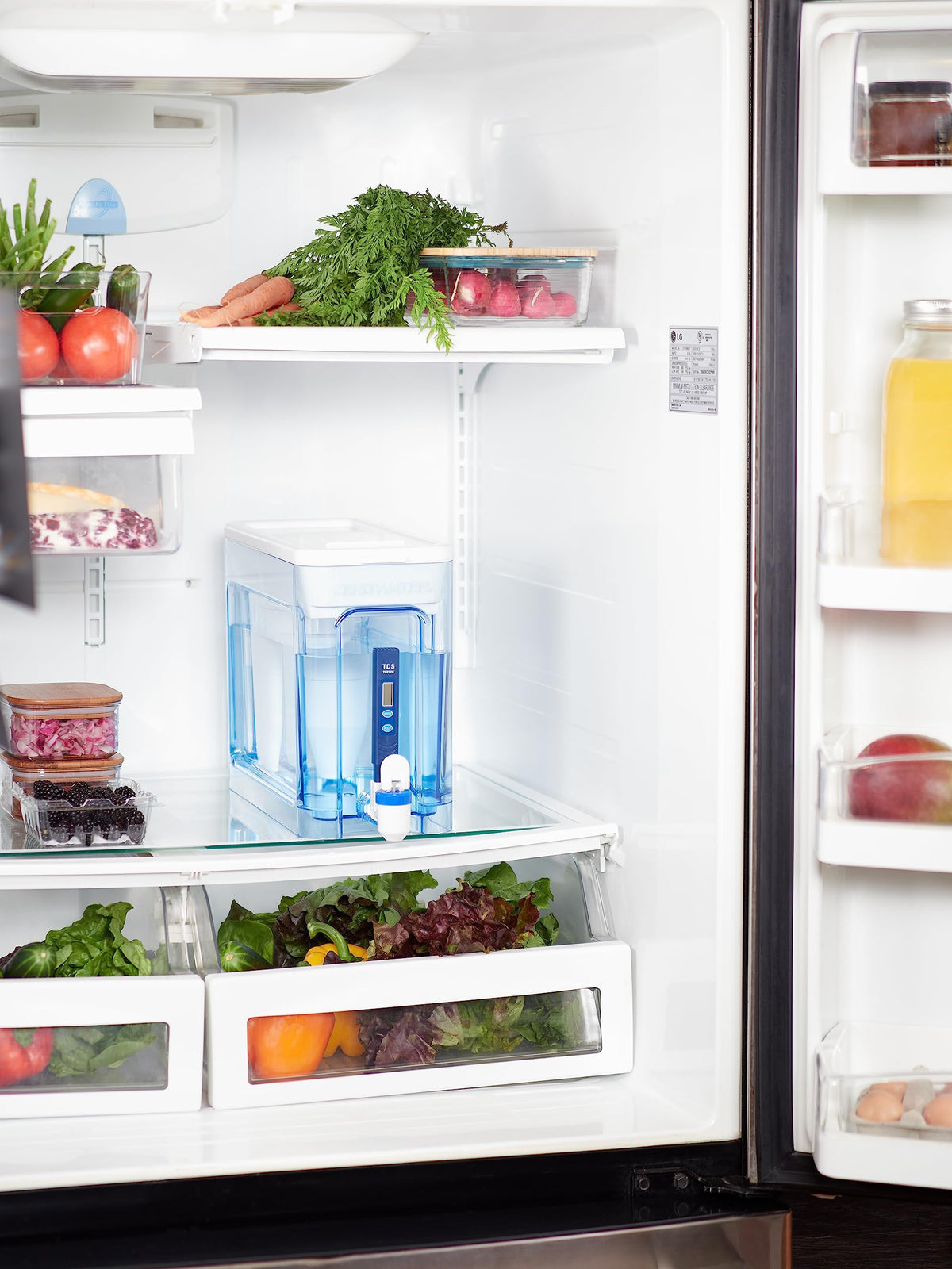 Pouring water from the ZeroWater 32-cup dispenser for daily use.