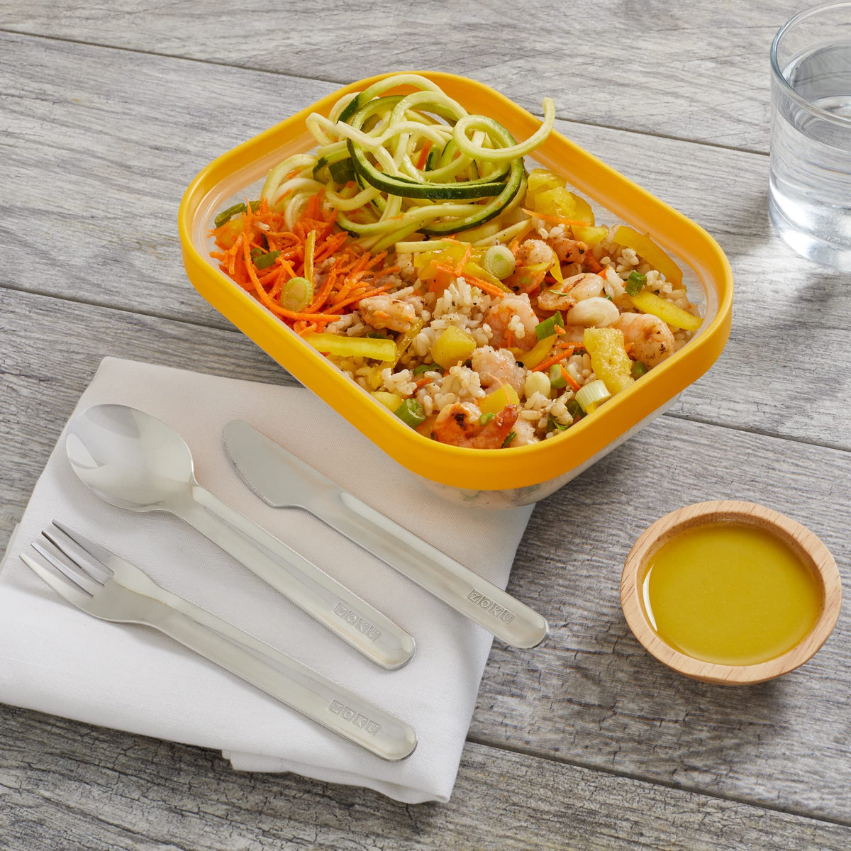 ZOKU pocket utensil set showcased during picnic, stainless steel finish handles meals elegantly.