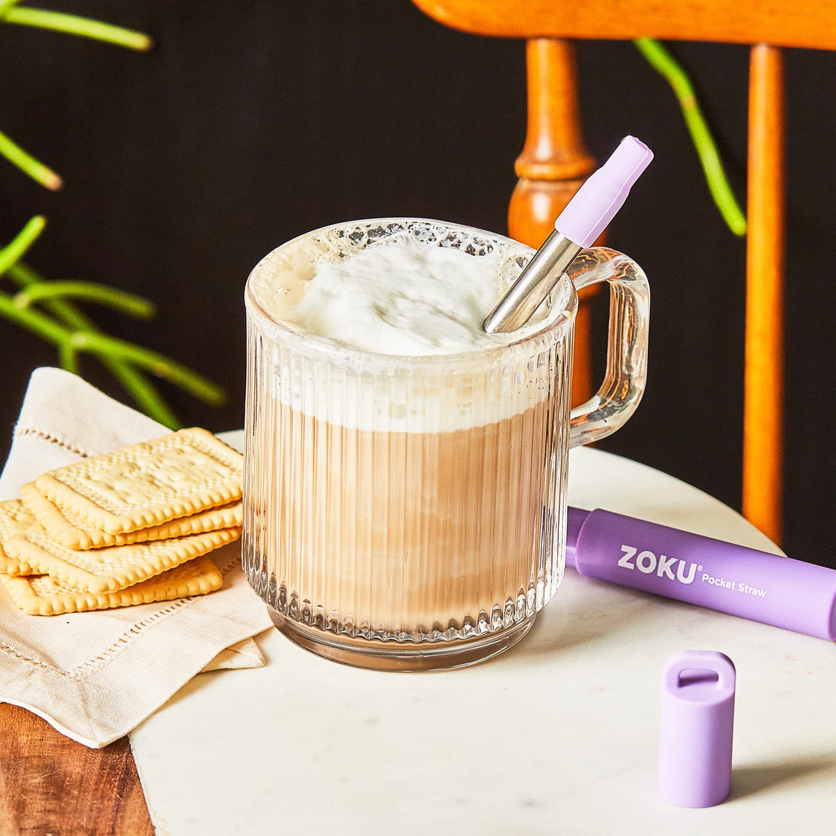 ZOKU travel-friendly straw held in hand for on-the-go sipping