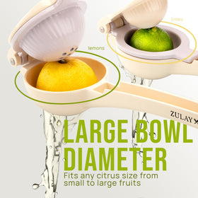 Zulay Kitchen metal 2-in-1 squeezer dispensing juice into a glass.