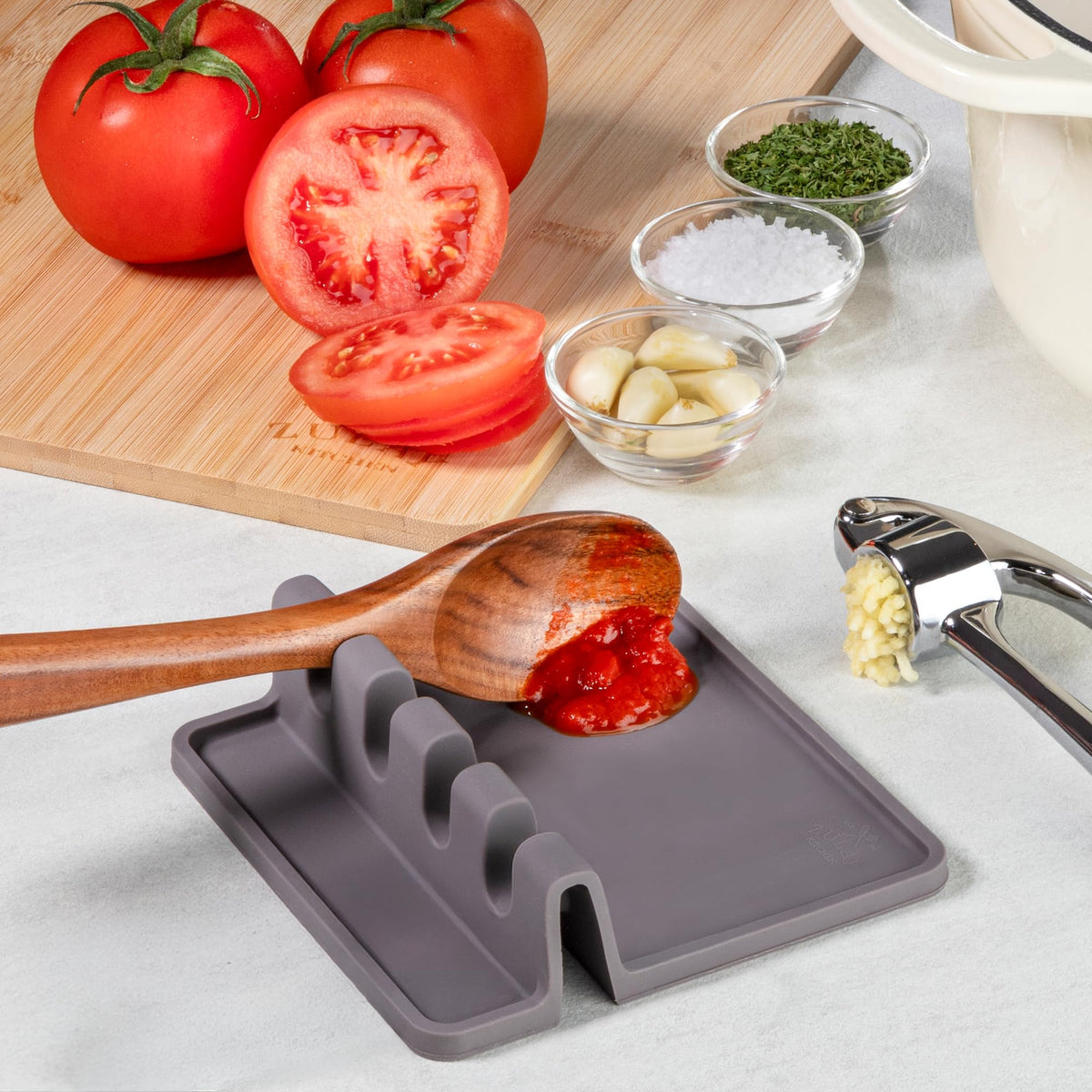 Zulay Kitchen spoon rest in use with ladles, spatulas, and tongs