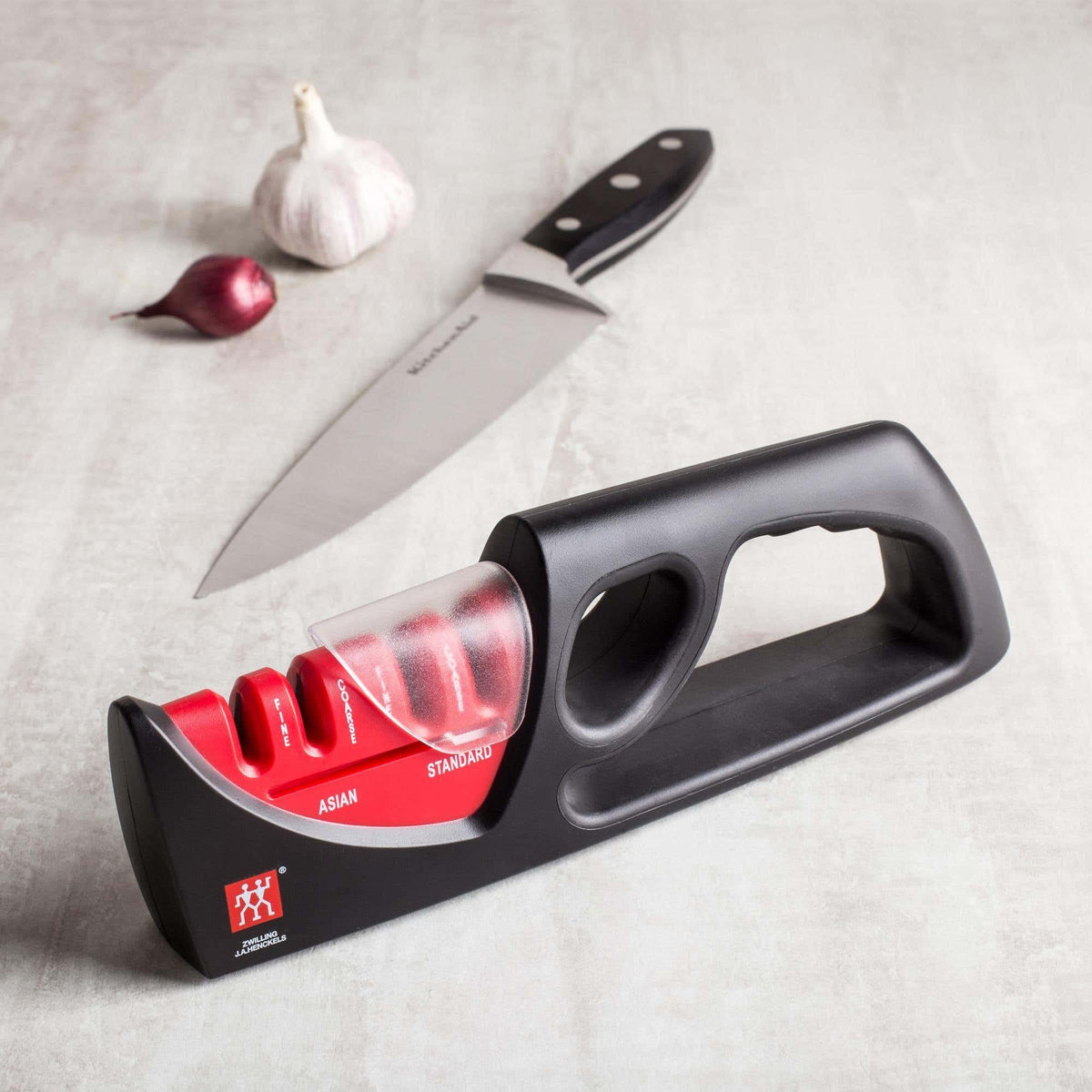 ZWILLING sharpener coarse-fine rod close-up demonstrating ceramic sharpening action.